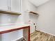 Laundry room with built-in shelving and vinyl flooring at 24601 Blue Heron Cir, Lancaster, SC 29720