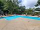 Community pool with plenty of lounge chairs and patio tables at 5020 Sardis Rd # N, Charlotte, NC 28270