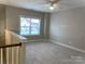 Spacious bedroom with carpeted floor and a large window at 173 Fulworth Dr, Concord, NC 28027