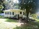 Charming ranch home with covered porch and well-maintained landscaping at 102 Aderholdt Rd, Bessemer City, NC 28016
