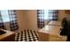 Laundry room with washer, dryer, and checkered floor at 102 Aderholdt Rd, Bessemer City, NC 28016