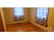 Simple bedroom with wood floors and plaid curtains at 102 Aderholdt Rd, Bessemer City, NC 28016