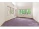 Bright office space with large windows and purple carpet at 1346 Hill Rd, Charlotte, NC 28210