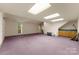 Spacious studio room with purple carpet, ample natural light, and storage at 1346 Hill Rd, Charlotte, NC 28210