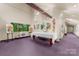 Spacious art studio with high ceilings, artwork, and purple carpet at 1346 Hill Rd, Charlotte, NC 28210