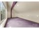 Large studio room with purple carpet and a window offering natural light at 1346 Hill Rd, Charlotte, NC 28210