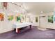 Bright art studio with hardwood floors, multiple art pieces, and a white table at 1346 Hill Rd, Charlotte, NC 28210