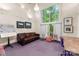 Relaxing studio area with large window, leather couch, and work area at 1346 Hill Rd, Charlotte, NC 28210