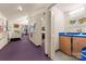 Hallway leading to studio space with artwork and a kitchenette at 1346 Hill Rd, Charlotte, NC 28210