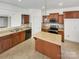 Modern kitchen with island, stainless steel appliances, and light wood cabinets at 6611 Buck Horn Pl, Waxhaw, NC 28173