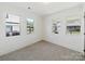 Bright bedroom with neutral carpeting and multiple windows at 178 Tournament Dr, Concord, NC 28025