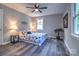 Charming bedroom with ceiling fan and floral bedding at 1229 Golf Course Dr, Gastonia, NC 28054