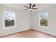 Bright bedroom with hardwood floors and two windows at 103 Apricot St, Belmont, NC 28012