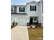 Two-story house with white siding, black shutters, and a two-car garage at 1634 Village Grove Ln, Monroe, NC 28110