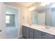 Double vanity bathroom with gray cabinets and a walk-in shower at 3637 West Bay Dr, Sherrills Ford, NC 28673