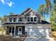 Two-story house with gray siding, stone accents, and a two-car garage at 3637 West Bay Dr, Sherrills Ford, NC 28673