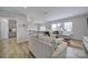 Bright living room with L-shaped sectional sofa and kitchen view at 1816 Teachers House Nw Rd, Concord, NC 28027