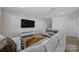 Living room with sectional sofa and large TV at 1816 Teachers House Nw Rd, Concord, NC 28027