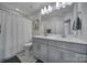 Modern bathroom with double vanity, gray cabinets, and a shower/tub combo at 1816 Teachers House Nw Rd, Concord, NC 28027