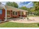 Brick home with a covered porch, decorative stone, and landscaping at 214 Ruth St, Rockwell, NC 28138