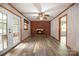 Living room with brick fireplace, wood-look floors, and french doors at 214 Ruth St, Rockwell, NC 28138