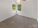 Bright bedroom featuring gray carpet and corner windows at 8527 Woodhill Manor Ct, Charlotte, NC 28215