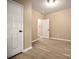 Bright bedroom with neutral walls, wood-look floors and a door to hallway at 1116 N Lafayette St, Shelby, NC 28150