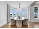 Round dining table with lake view, wood floors, and elegant chandelier at 19125 Peninsula Point Dr, Cornelius, NC 28031
