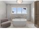 Luxurious bathroom with soaking tub and marble tile at 19125 Peninsula Point Dr, Cornelius, NC 28031