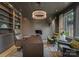 Home office with built-in shelving, leather chairs, and large window at 19125 Peninsula Point Dr, Cornelius, NC 28031