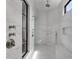 Large walk-in shower with marble walls and multiple shower heads at 19125 Peninsula Point Dr, Cornelius, NC 28031
