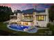 Luxury lakefront home with stone exterior, pool, and expansive patio at 19125 Peninsula Point Dr, Cornelius, NC 28031