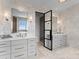 Spa-like bathroom with marble tile and double vanity at 19125 Peninsula Point Dr, Cornelius, NC 28031