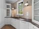Butlery with dark countertop, white cabinetry, and subway tile at 19125 Peninsula Point Dr, Cornelius, NC 28031