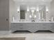 Double vanity with marble countertops, large mirrors, and grey cabinets at 19125 Peninsula Point Dr, Cornelius, NC 28031
