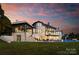 Luxury home with stone exterior, expansive patio, and a beautiful pool at 19125 Peninsula Point Dr, Cornelius, NC 28031