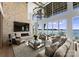 Living room boasts high ceilings, stone fireplace, and stunning lake views at 19125 Peninsula Point Dr, Cornelius, NC 28031