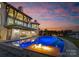 Luxury pool and patio area with fire pit, at sunset at 19125 Peninsula Point Dr, Cornelius, NC 28031