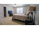 Bright bedroom with a queen-size bed, TV, and ample closet space at 1017 Silver Springs Rd, Fort Mill, SC 29715