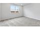 Simple bedroom with gray carpeting and a window offering natural light at 2243 Carpenter Farms Dr, Lincolnton, NC 28092