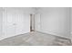 Well-lit bedroom featuring grey carpet and double closet doors at 2243 Carpenter Farms Dr, Lincolnton, NC 28092