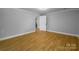 Bright bedroom with wood floors and access to other rooms at 307 S Ransom St, Gastonia, NC 28052