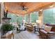 Bright sunroom features a stone fireplace, comfortable seating, and a ceiling fan at 534 Coman Ln, Kings Mountain, NC 28086