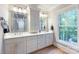 Elegant bathroom boasts double vanities, a large mirror, and a window overlooking the backyard at 534 Coman Ln, Kings Mountain, NC 28086