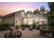 Evening view of the backyard patio with fire pit and comfortable seating at 534 Coman Ln, Kings Mountain, NC 28086
