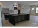 Open kitchen boasts an expansive island and stylish pendant lighting at 3656 Raymond Loop, Newton, NC 28658