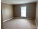 Spacious bedroom with neutral walls and carpeting at 300 N Fulton St # 11, Salisbury, NC 28144