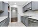 Modern kitchen with gray cabinets and marble countertops at 4754 Hedgemore Dr # T, Charlotte, NC 28209