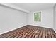 Bright bedroom with wood-look floors and a window at 4754 Hedgemore Dr # T, Charlotte, NC 28209