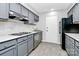 Modern kitchen with gray cabinets and marble countertops at 4754 Hedgemore Dr # T, Charlotte, NC 28209